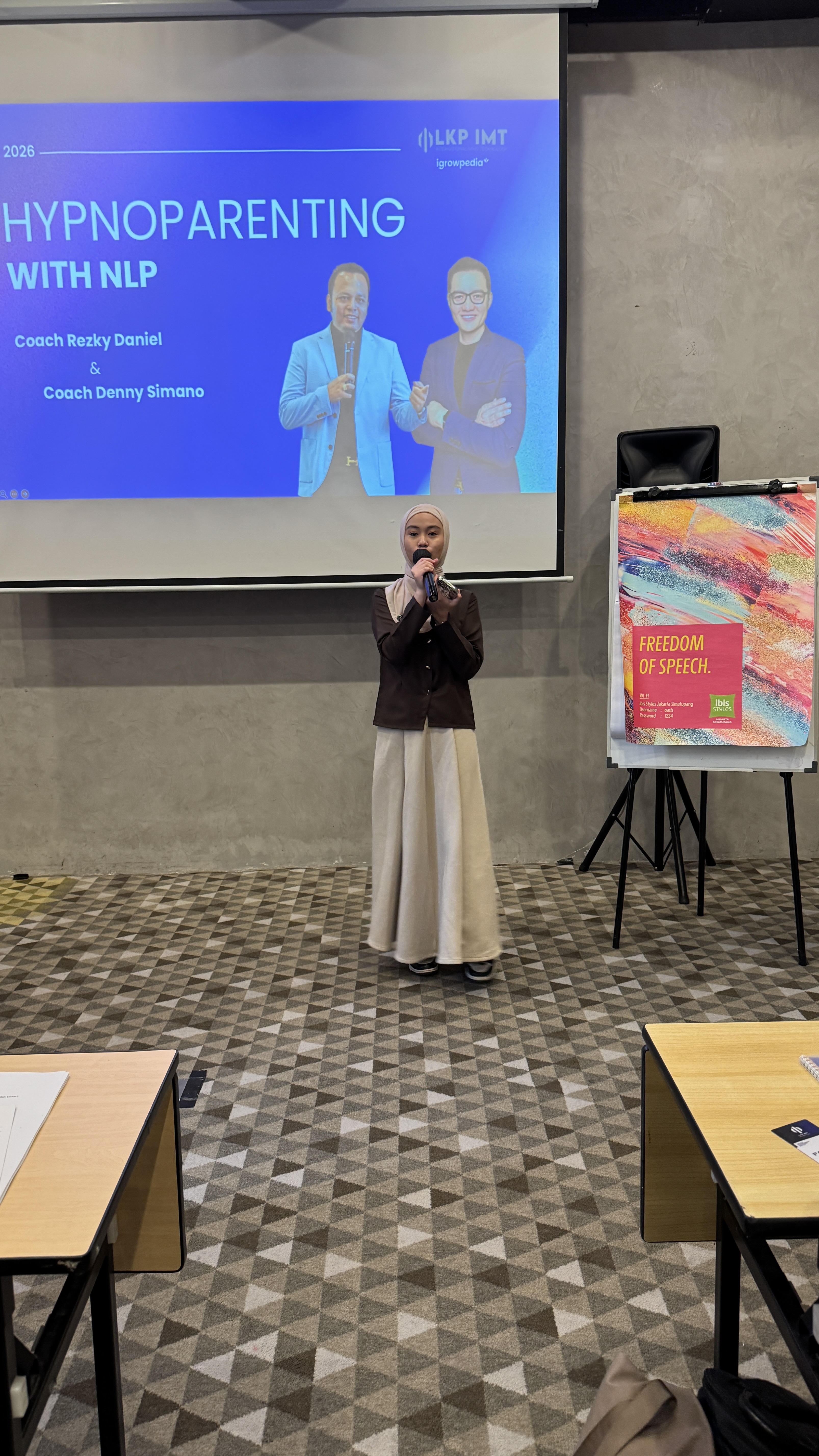 Reina in front of Hypnoparenting with NLP presentation